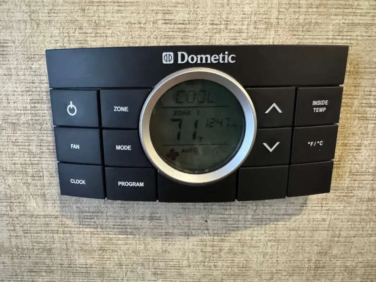 Dometic RV wall thermostat panel displaying cool mode at 71 degrees